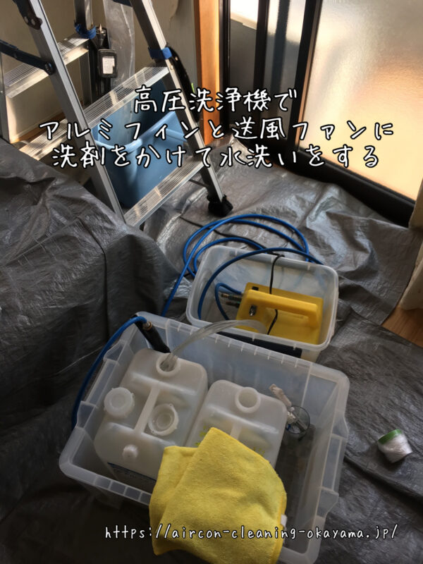 高圧洗浄機でアルミフィンと送風ファンに洗剤をかけて水洗いをする